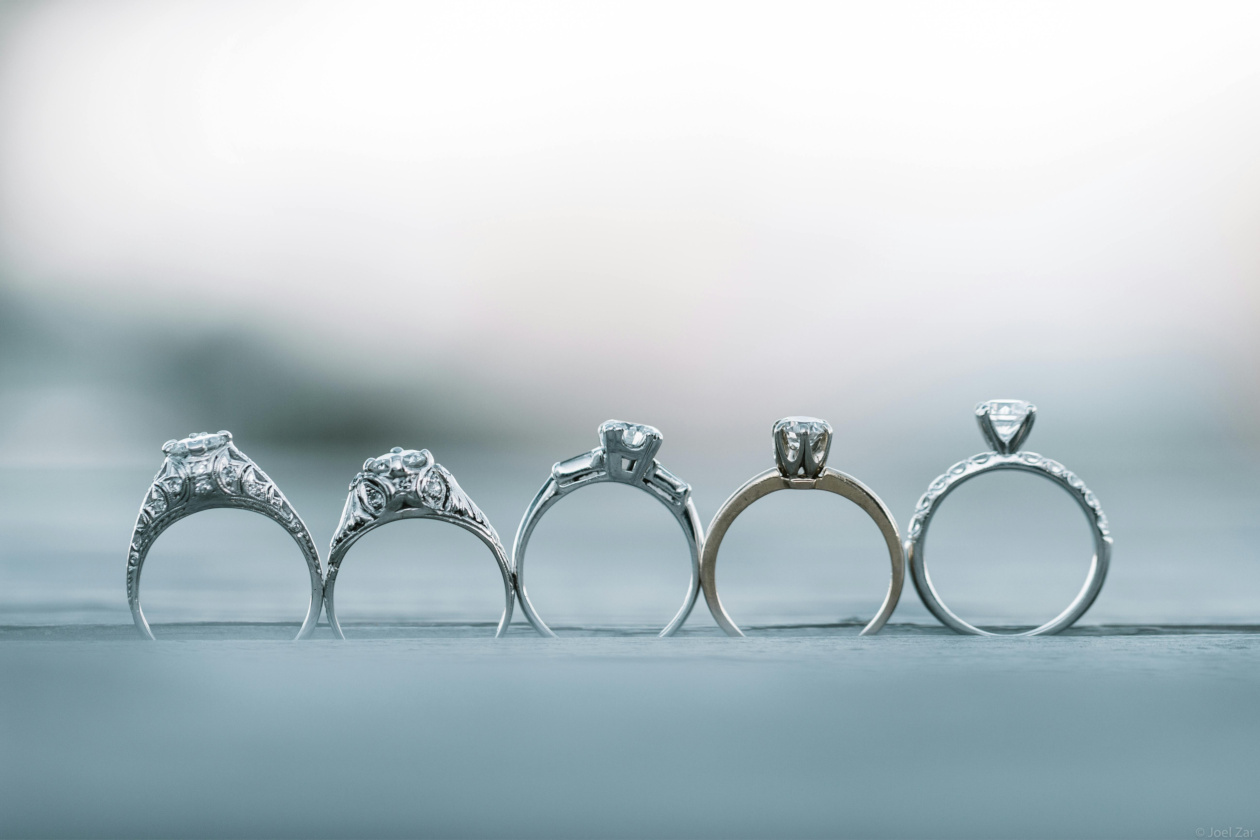 Pictured: Five unique rings sitting in a line overlooking a blurred landscape